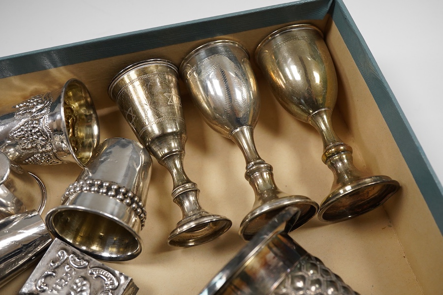 A pair of George V silver kiddush cups, maker M.S., London, 1919, 9cm, one other silver kiddush cup, two Judaic sterling tots, a set of eight Polish white metal tots, maker SJ, one other pair of Polish white metal tots,
